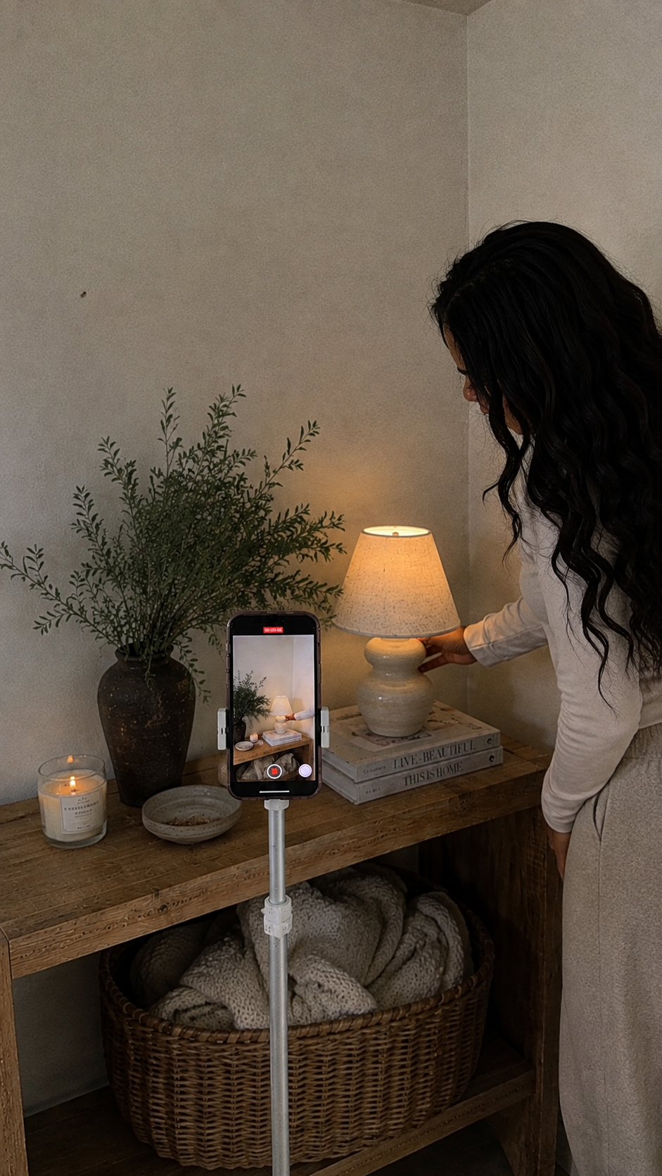 Heather recording UGC content on a phone tripod in a styled home scene